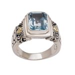Gold accented blue topaz single stone ring, 'Blue Extravaganza' - Handmade Blue Topaz Single Stone Ring with Gold Accents