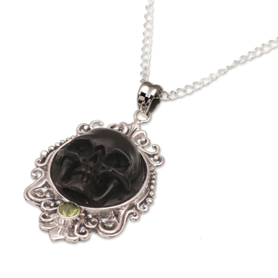 Peridot pendant necklace, 'Skull Stare in Black' - Peridot and Bone Black Skull Pendant Necklace from Bali
