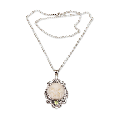 Peridot pendant necklace, 'Skull Stare in White' - Peridot and Bone White Skull Pendant Necklace from Bali