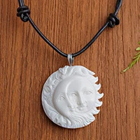 Bone pendant necklace, 'Stellar Guardians' - Handcrafted Sun and Moon Bone Pendant Necklace from Bali