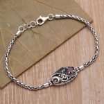 Garnet and blue topaz pendant bracelet, 'Crashing Waves' - Sterling Silver Blue Topaz and Garnet Pendant Bracelet