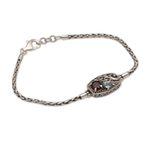 Garnet and blue topaz pendant bracelet, 'Crashing Waves' - Sterling Silver Blue Topaz and Garnet Pendant Bracelet
