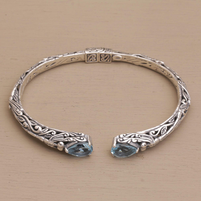 Blue topaz cuff bracelet, 'Looking for You' - Sterling Silver Hinged Blue Topaz Cuff Bracelet from Bali