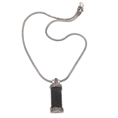 Garnet and leather pendant necklace, 'Strength and Grace' - Garnet and Leather Necklace in Sterling Silver from Bali