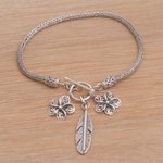 Sterling silver charm bracelet, 'Jepun Spirals' - Sterling Silver Frangipani Flower Charm Bracelet from Bali