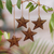 Coconut shell ornaments, 'Bright Lights in the Sky' (set of 4) - Set of 4 Handmade Brown Coconut Shell Star Ornaments