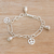 Sterling silver charm bracelet, 'Peaceful Infinity' - Sterling Silver Peace Symbol Charm Bracelet from Bali