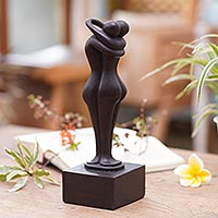 Wood sculpture, 'Meeting You' - Hand-Carved Black Suar Wood Embracing Couple Sculpture