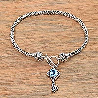 Blue topaz charm bracelet, 'Beauty Unlocked in Blue' - Blue Topaz and Sterling Silver Key Charm Bracelet from Bali