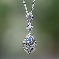 Blue topaz pendant necklace, 'Tari Lotus' - Floral Blue Topaz Pendant Necklace from Bali