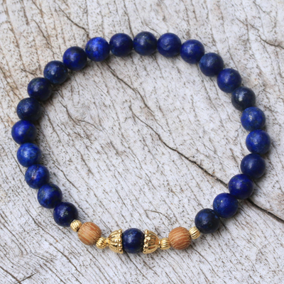 Gold accented lapis lazuli beaded stretch bracelet, 'Batuan Tune' - Gold Accented Lapis Lazuli Beaded Stretch Bracelet from Bali