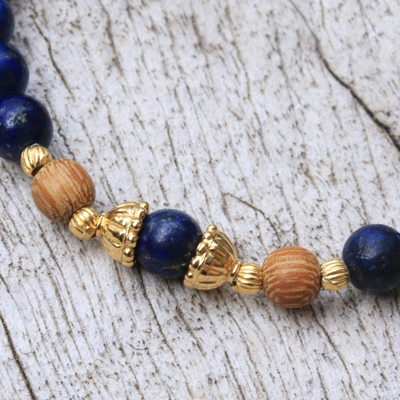 Gold accented lapis lazuli beaded stretch bracelet, 'Batuan Tune' - Gold Accented Lapis Lazuli Beaded Stretch Bracelet from Bali