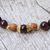 Gold accented garnet beaded stretch bracelet, 'Batuan Tune' - Gold Accented Garnet Beaded Stretch Bracelet from Bali