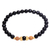 Gold accented onyx beaded stretch bracelet, 'Batuan Tune' - Gold Accented Onyx Beaded Stretch Bracelet from Bali