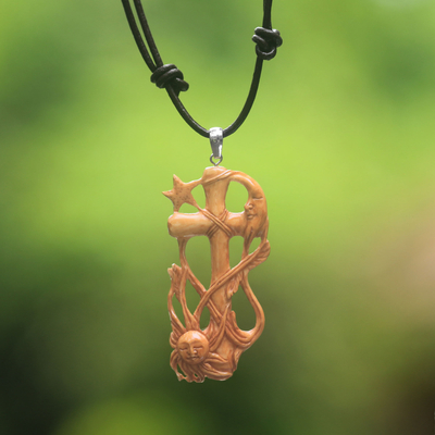 Bone pendant necklace, 'Faithful Sun and Moon' - Hand-Carved Bone Cross Pendant Necklace from Bali