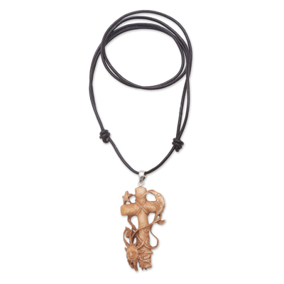 Bone pendant necklace, 'Faithful Sun and Moon' - Hand-Carved Bone Cross Pendant Necklace from Bali