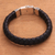 Men's leather braided wristband bracelet, 'Jagaraga Swirl' - Men's Sterling Silver and Braided Black Leather Bracelet