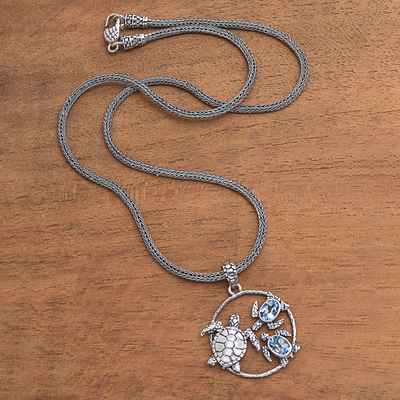Blue topaz pendant necklace, 'Sea Turtle Family' - Blue Topaz Sea Turtle Pendant Necklace from Bali