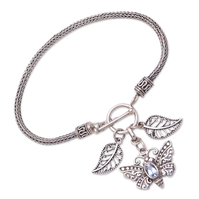 Blue topaz charm bracelet, 'Beaming Butterfly' - Sterling Silver and Blue Topaz Butterfly Charm Bracelet