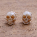 Bone stud earrings, 'Faces of Trunyan' - Hand-Carved Skull Bone Stud Earrings from Bali