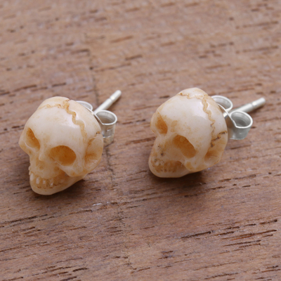 Bone stud earrings, 'Faces of Trunyan' - Hand-Carved Skull Bone Stud Earrings from Bali