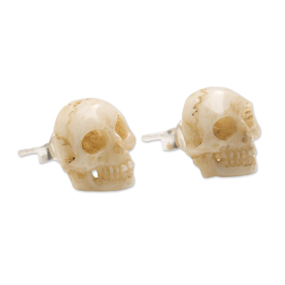 Bone stud earrings, 'Faces of Trunyan' - Hand-Carved Skull Bone Stud Earrings from Bali