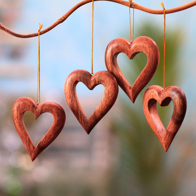 Wood ornaments, 'Heart Grain' (set of 4) - Heart-Shaped Suar Wood Ornaments from Bali (Set of 4)