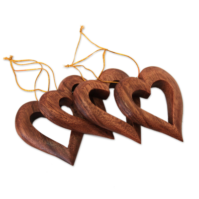 Wood ornaments, 'Heart Grain' (set of 4) - Heart-Shaped Suar Wood Ornaments from Bali (Set of 4)