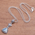 Blue topaz pendant necklace, 'Triangle of Swirls' - Triangular Blue Topaz Pendant Necklace from Bali thumbail