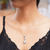 Blue topaz pendant necklace, 'Triangle of Swirls' - Triangular Blue Topaz Pendant Necklace from Bali