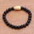 Gold accented onyx beaded stretch bracelet, 'Fierce Snake' - Gold Accented Snake-Themed Onyx Beaded Stretch Bracelet