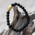 Gold accented onyx beaded stretch bracelet, 'Bear's S'trength - Gold Accented Bear-Themed Onyx Beaded Stretch Bracelet