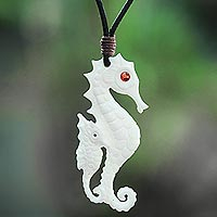Bone and garnet pendant necklace, 'Caring Seahorse' - Seahorse Pendant Necklace from Bali