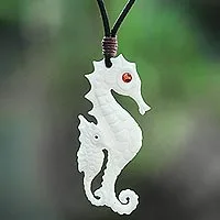 Bone and garnet pendant necklace, 'Caring Seahorse' - Bone and Garnet Seahorse Pendant Necklace from Bali