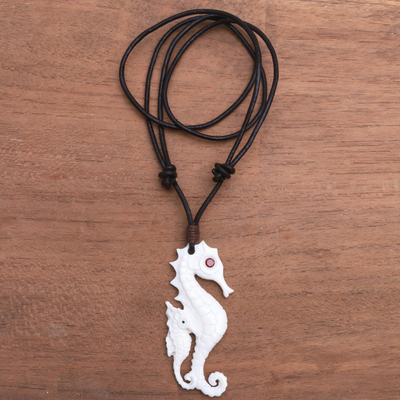 Bone and garnet pendant necklace, 'Caring Seahorse' - Bone and Garnet Seahorse Pendant Necklace from Bali