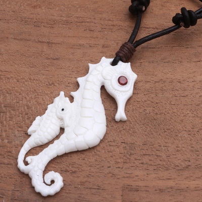 Bone and garnet pendant necklace, 'Caring Seahorse' - Bone and Garnet Seahorse Pendant Necklace from Bali