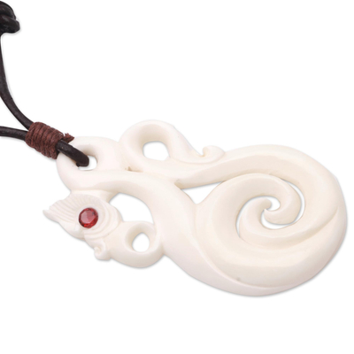 Bone and garnet pendant necklace, 'Celtic Sea Serpent' - Swirl Pattern Pendant Necklace from Bali