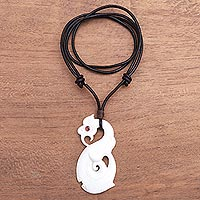 Bone and garnet pendant necklace, 'Swirling Glory' - Swirl Pattern Garnet Pendant Necklace from Bali
