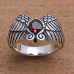 Garnet cocktail ring, 'Winged Glitter' - Wing Motif Garnet Band Ring from Bali