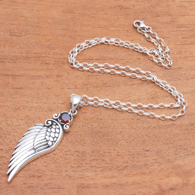 Garnet pendant necklace, 'One Wing' - Wing-Themed Garnet Pendant Necklace from Bali