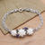 Amethyst pendant bracelet, 'Ivory Lotus' - Silver and Amethyst Bracelet with Carved Bone Flowers