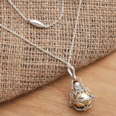 Garnet harmony ball necklace, 'Protective Love' - Silver and Brass Harmony Ball Necklace with Garnet