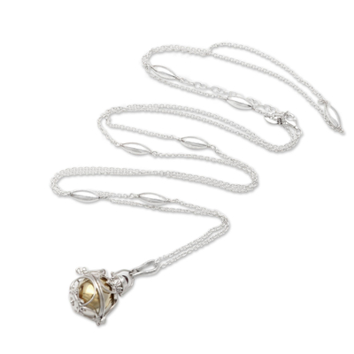 Garnet harmony ball necklace, 'Protective Love' - Silver and Brass Harmony Ball Necklace with Garnet