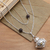 Garnet and peridot harmony ball long necklace, 'Plumeria Chime' - Silver & Garnet Plumeria Harmony Ball Necklace with Peridot (image 2) thumbail
