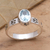 Blue topaz single-stone ring, 'Pawprints' - Faceted Blue Topaz Sterling Silver Ring with Pawprint Motif thumbail