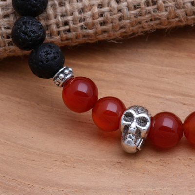 Lava stone and carnelian beaded stretch bracelet, 'Staring Skull in Scarlet' - Skull Pendant Carnelian and Lava Stone Beaded Bracelet