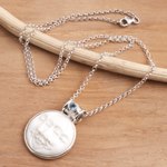 Blue topaz pendant necklace, 'Moon Phase Faces' - Blue Topaz and Sterling Silver Moon Pendant Necklace
