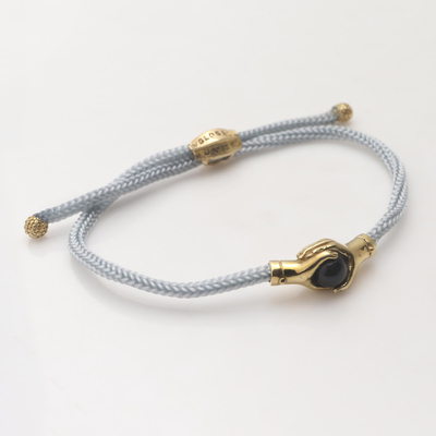 Brass and black agate unity bracelet, 'Golden Grey Handshake' - Bali Brass and Black Agate Grey Cord Unity Bracelet