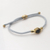 Brass and black agate unity bracelet, 'Golden Grey Handshake' - Bali Brass and Black Agate Grey Cord Unity Bracelet (image 2b) thumbail