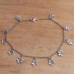 Sterling silver charm anklet, 'Glimmering Flowers' - Sterling Silver Floral Charm Anklet from Bali